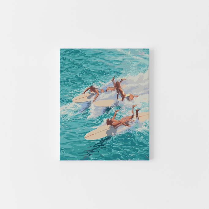 Paint Like Frida’s ‘Chaos’ Big Rolled Canvas – a paint by numbers kit featuring five sun-kissed surfers crashing into turquoise waves on creamy white longboards, mid-action and full of summer energy.