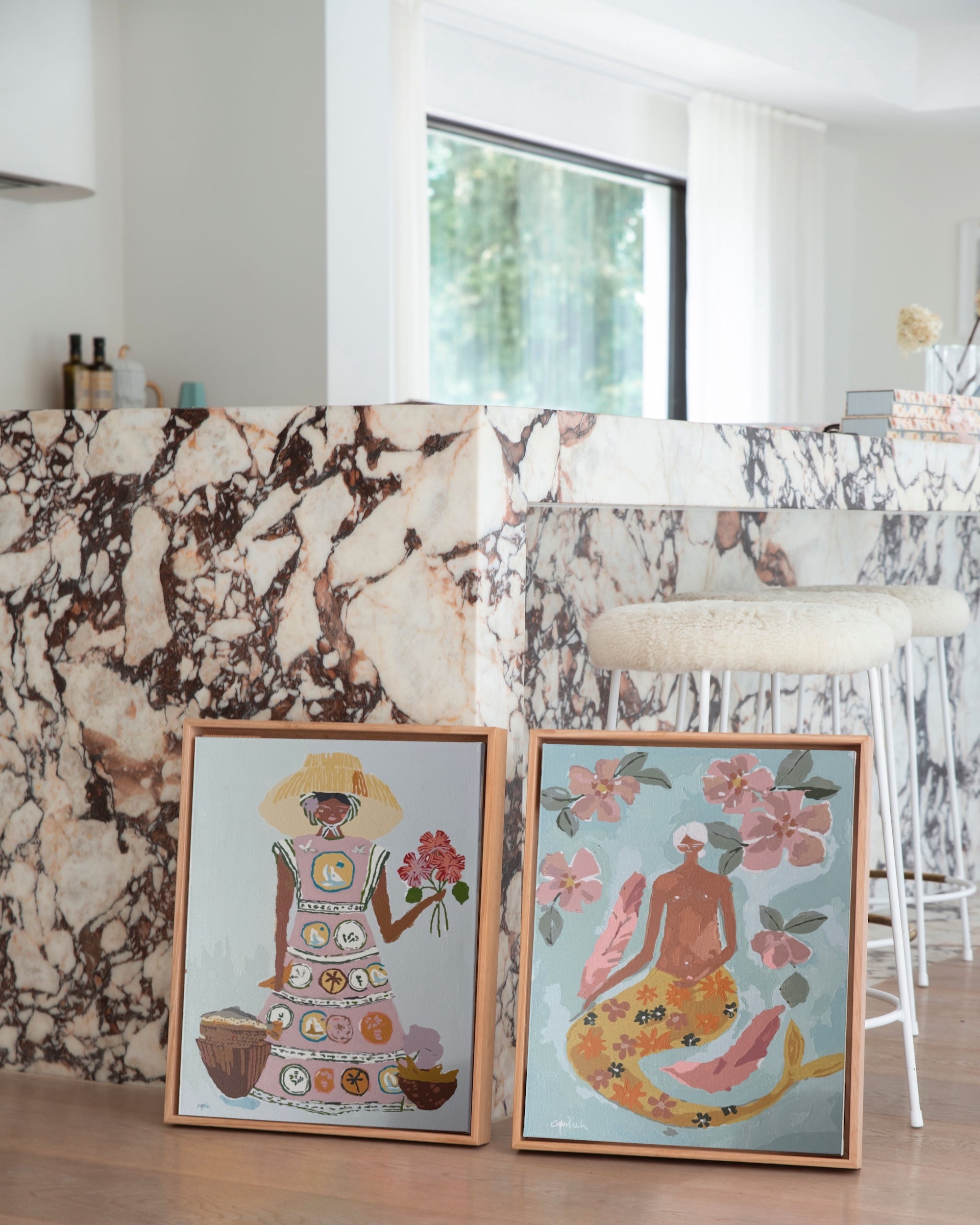 Paint Like Frida’s Patience and Lady of the Sea Mini Framed Canvases, styled on a marble bench — two bold, feminine paint by numbers artworks in small custom floating frames, adding colour and warmth to a modern space.